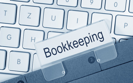 Bookkeeping - folder on computer keyboardの写真素材