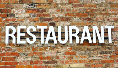 Old Restaurant sign on stone wall