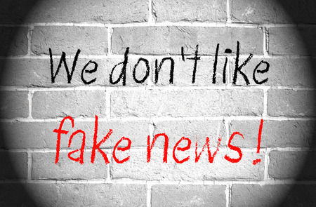 We do not like fake news - brick wall with textの写真素材