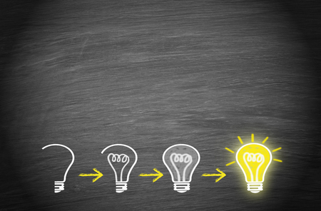 Light bulbs on chalkboard backgroundの写真素材