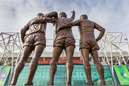 Manchester, England - February 27, 2016: On 29 May 2008, to celebrate the 40th anniversary of Manchester United's first European Cup title, a statue of the club's holy trinity of George Best, Denis Law and Bobby Charlton, entitled The United Trinity, was のeditorial素材