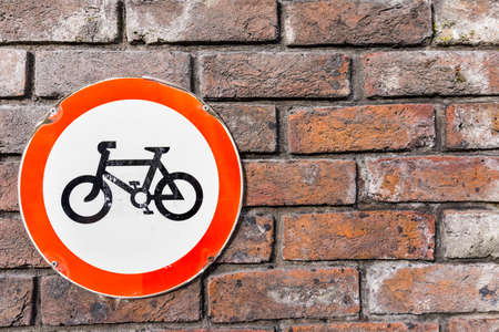 bicycle sign on brick wallの写真素材