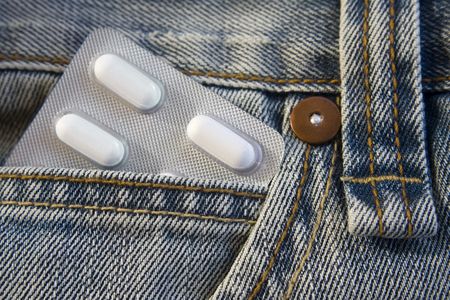 Blister pack of pills in the jeans pocketの写真素材