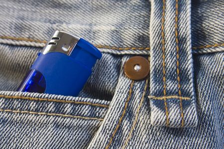 Blue lighter in washed, stylish jeans pocketの写真素材