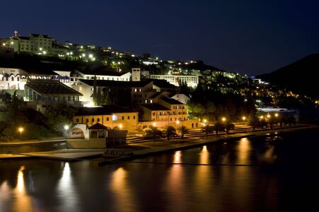 Seaside resort by night, illuminated by street lampsの写真素材