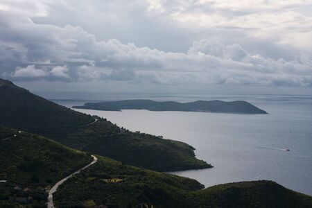 Mediterranean, narrow, seaside road among mountainsの写真素材