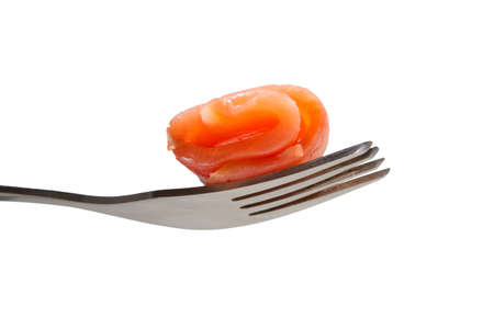 Roll of salmon slice on a fork, isolated on whiteの写真素材