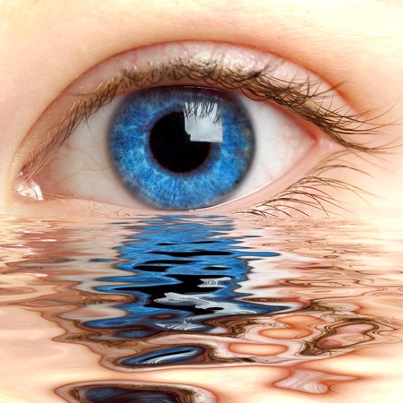 Human eye reflected in a surface of water の写真素材