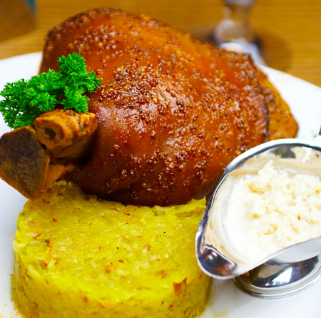 Pork leg with sauce, greens and cabbage.の写真素材