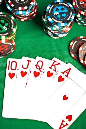 Playing cards on green cloth...