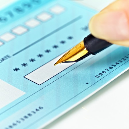 Close up of a pen and blank check.