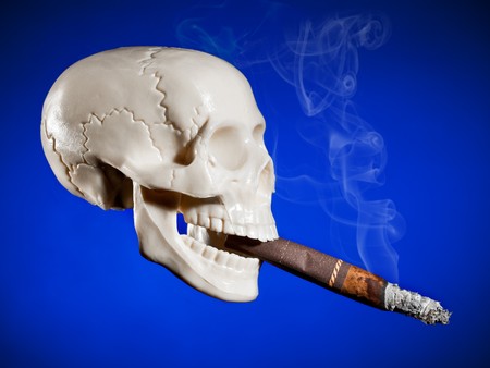 Smoking cigarette. Smoking skull on the blueの写真素材