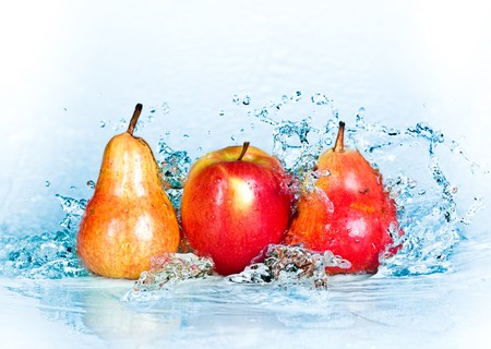 fresh water splash on red apple and pearの写真素材