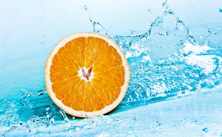 fresh water splash on orangeの写真素材