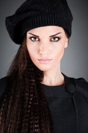 beautiful girl in a beret on the darkの写真素材