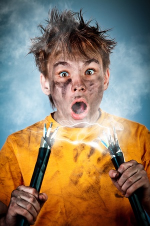 Electric shock sees a shocked boyの写真素材