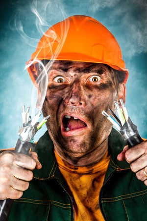 Electric shock sees a shocked electrician manの写真素材
