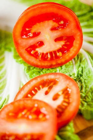 fresh cut tomatoes on salad sheetの写真素材