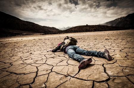 traveller lays on the dried groundの写真素材
