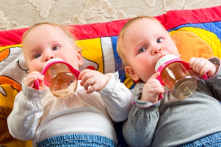 one years old baby eating from bottle