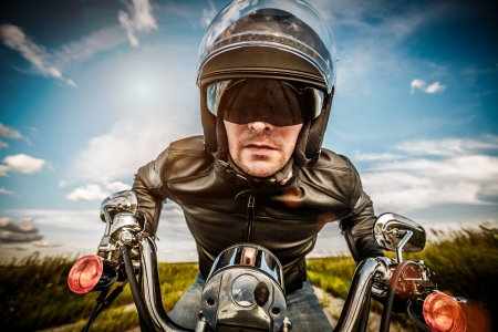 Biker in sunglasses and leather jacket racing on the road  fisheye lens の写真素材