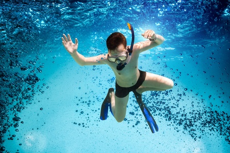 Freedive. Teenager in the mask and snorkel swim underwater.の写真素材