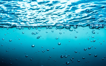 Many bubbles in water close up, abstract water wave with bubblesの写真素材