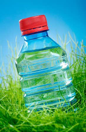 Bottle of water on the green grassの写真素材
