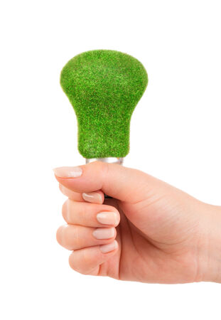 Eco light bulb in hand isolated on white backgroundの写真素材