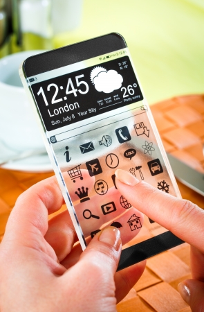 Smartphone (phablet) with a transparent display in human hands. Concept actual future innovative ideas and best technologies humanity.の写真素材
