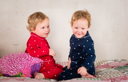 Children playing on bedの写真素材