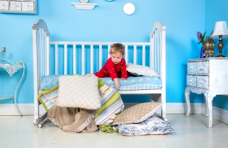 Baby playing on bedの写真素材