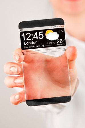 Futuristic Smart phone (copy space display) with a transparent display in human hands. Concept actual future innovative ideas and best technologies humanity.の写真素材