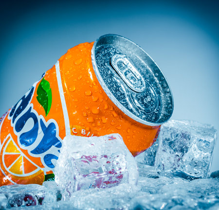 MOSCOW, RUSSIA-APRIL 4, 2014: Can of Coca Cola company soft drink Fanta Orange on ice. Fanta is a...