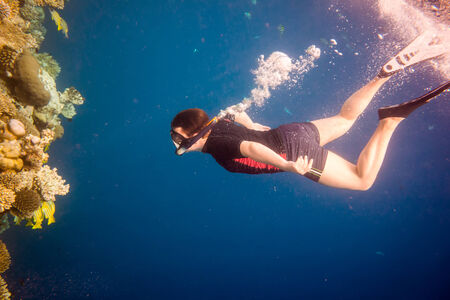 Snorkeler diving swimming under water.の写真素材