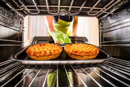 Housewife preparing cakes in the oven at home, view from the inside of the oven. Cooking in the oven.の写真素材