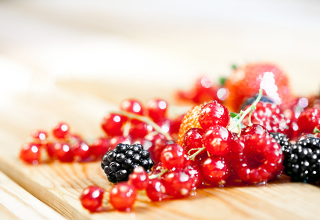 Wet currant on a wooden tableの写真素材