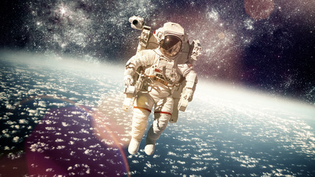 Astronaut in outer space against the backdrop of the planet earth.
