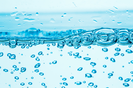 Many bubbles in water close up, abstract water wave with bubbles