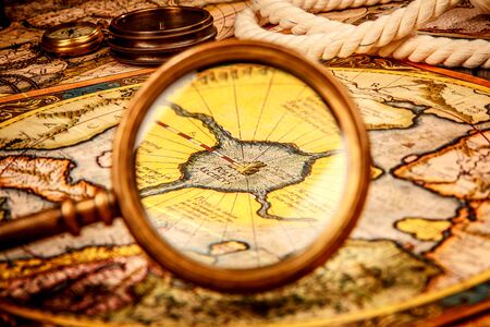 Vintage magnifying glass lies on the ancient map of the North Pole (also Hyperborea). Arctic continent on the Gerardus Mercator map of 1595.の写真素材