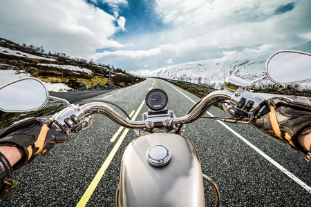Biker rides a motorcycle on mountain serpentine. First-person view. Biker rides a motorcycle on mountain serpentine. First-person view.