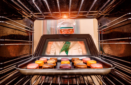Chef prepares macarons in the oven, view from the inside of the oven. Cooking in the oven.の写真素材