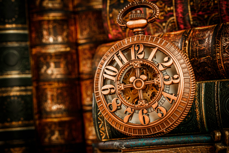 Vintage Antique pocket watch on the background of old booksの写真素材