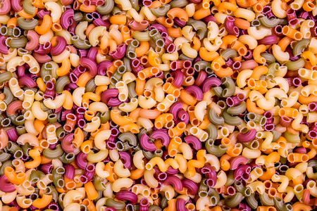 Background from multi-colored pasta, closeup filling the frame.の写真素材