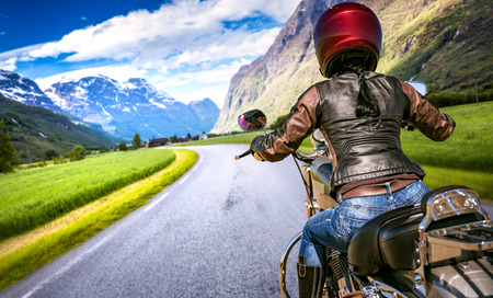 Biker girl rides a motorcycle in the rain. First-person view.の写真素材