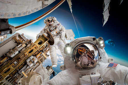 International Space Station and astronaut in outer space over the planet Earth.