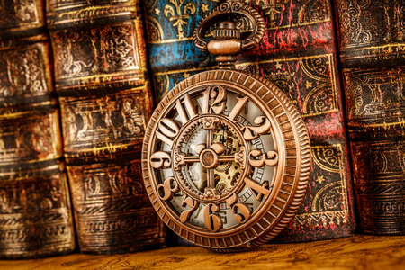 Vintage Antique pocket watch on the background of old booksの写真素材