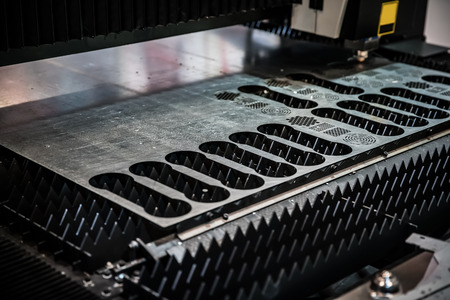 CNC Laser cutting of metal, modern industrial technology. Small depth of field. Warning - authentic...
