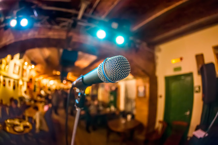 Microphone on stage against a background of auditoriumの写真素材