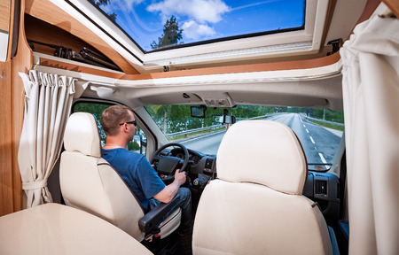 Man driving on a road in the Camper Van. Caravan car Vacation. Family vacation travel, holiday trip in motorhomeの写真素材